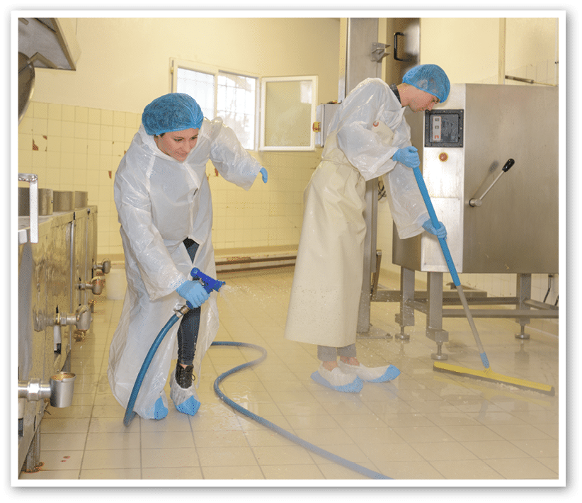 factory worker cleaning floor