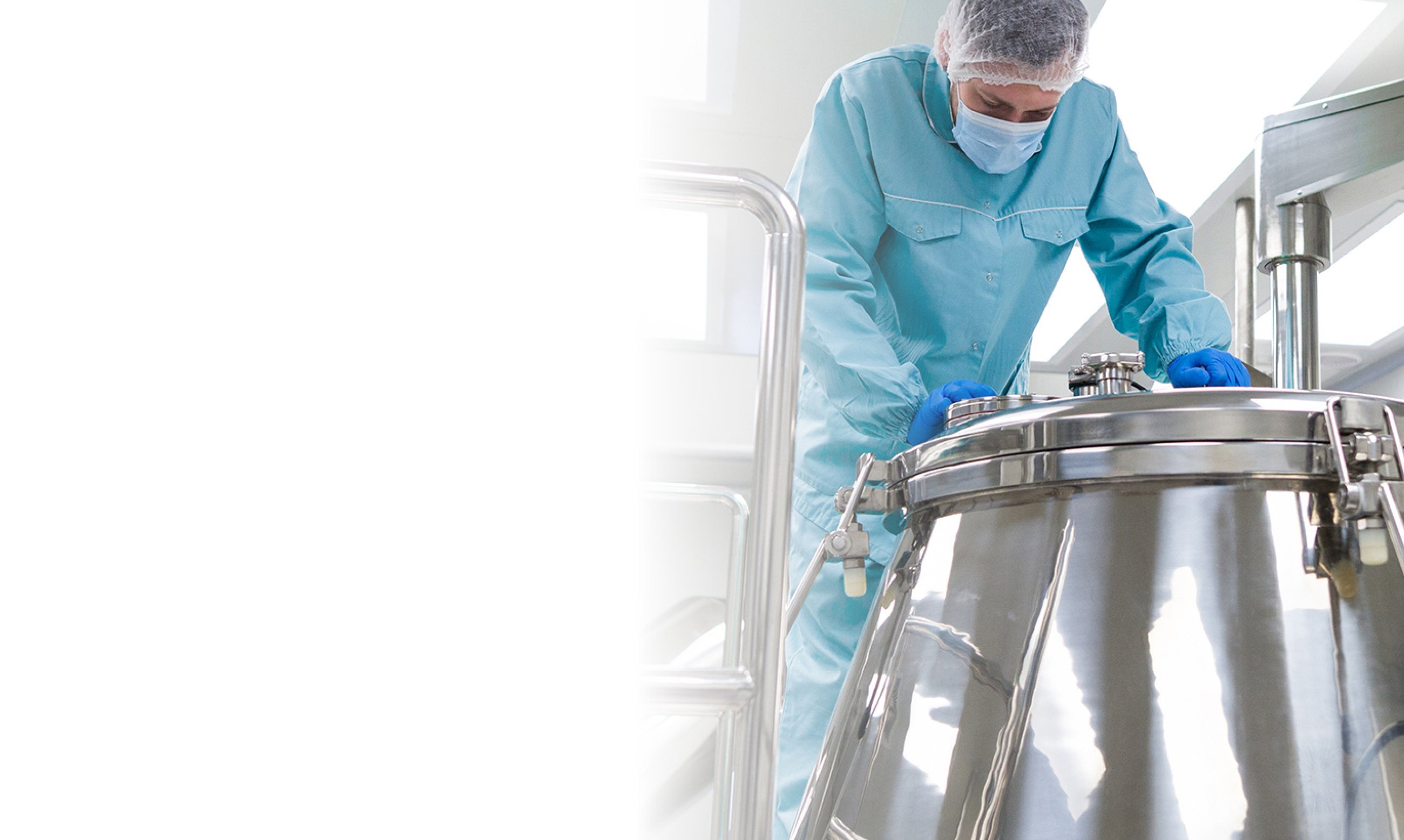 widescreen picture, caucasian scientist in blue lab suit and gloves stand on platform and look in the steel barrel