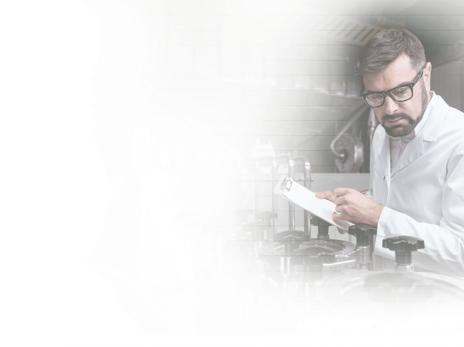 Control it properly. Serious concentrated handsome man noting work results while working on beer factory and wearing glasses.