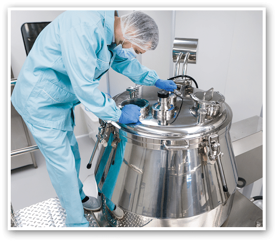 caucasian scientist in blue lab suit and gloves configure pressure on big steel tank
